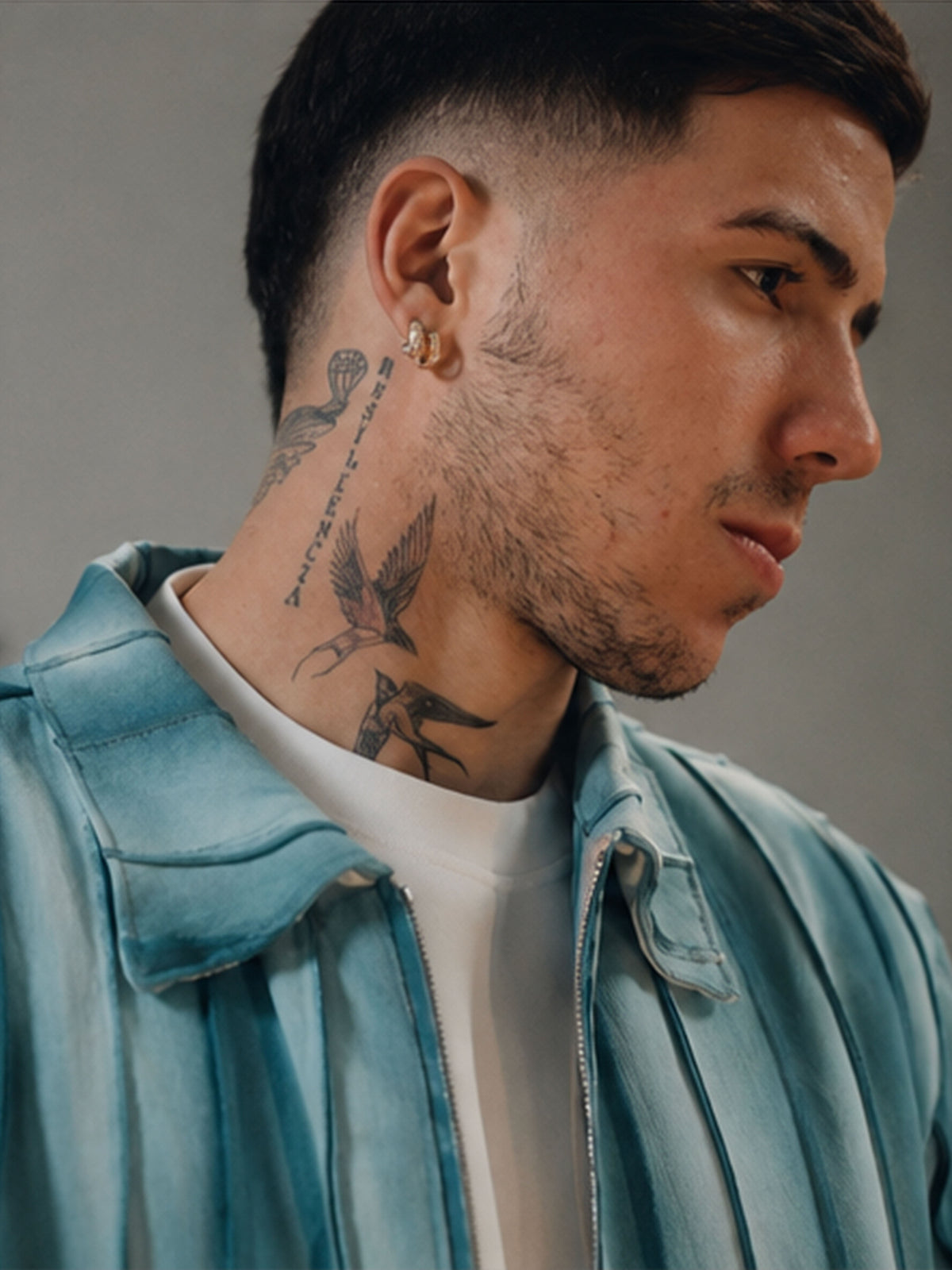 Enzo Fernandez wears BRYDER blue strap shirt in fashion shoot, close up, texture, detail.