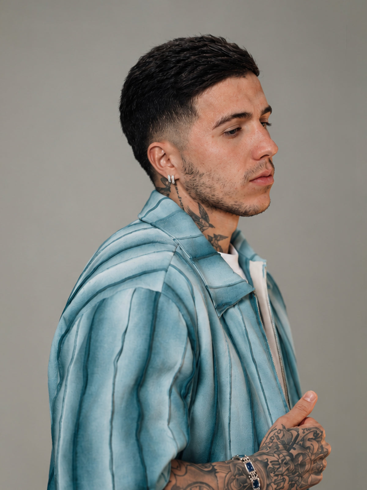 Enzo Fernandez wears BRYDER shirt in fashion shoot, close up, texture, detail.