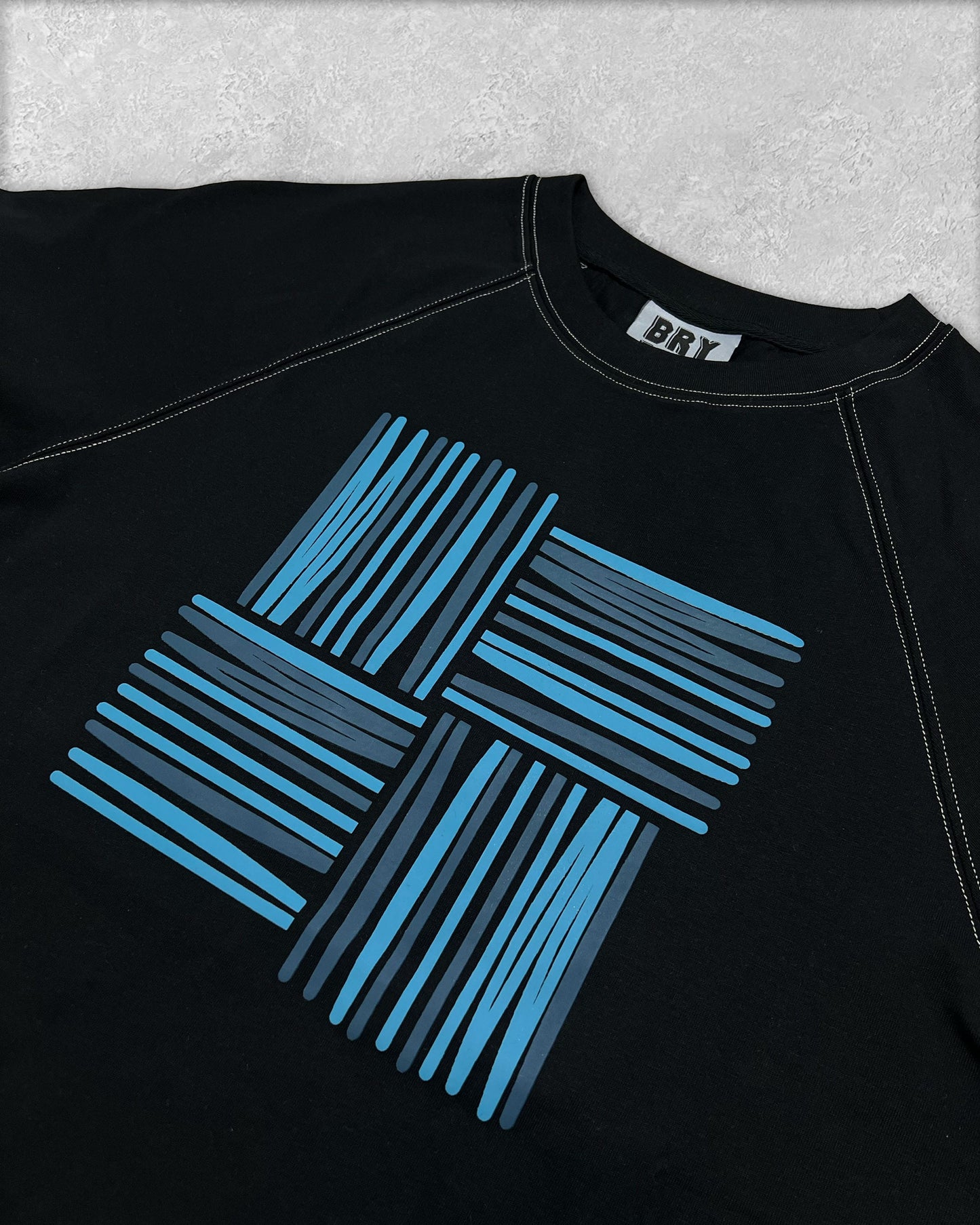 BRYDER Woven Logo Tee in Black — close-up product view